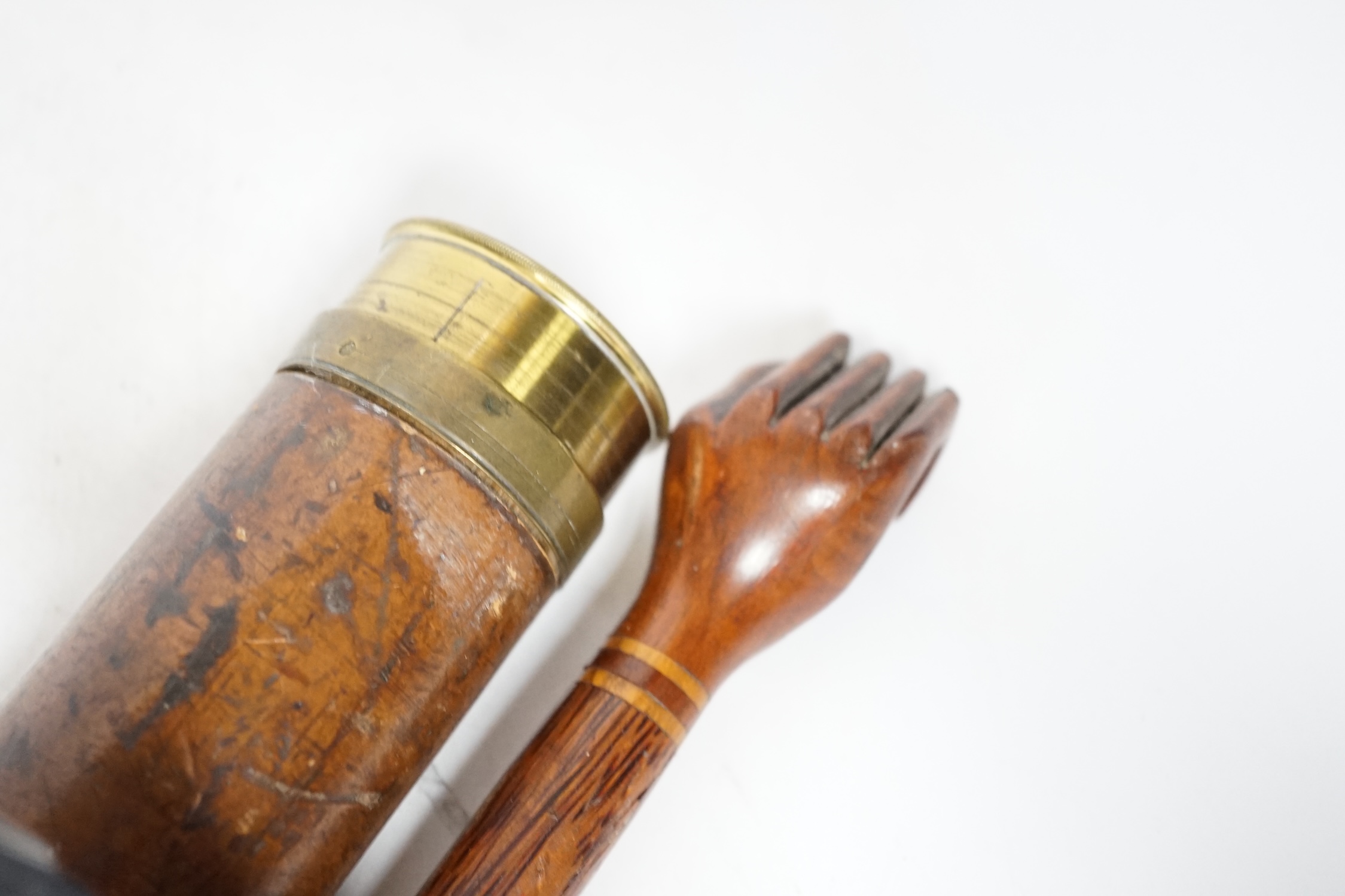 An inscribed cocus wood walking stick with carved handle in the form of a hand, ‘Pitcairn Island’ and a brass mounted two drawer telescope, largest 92cm in length
